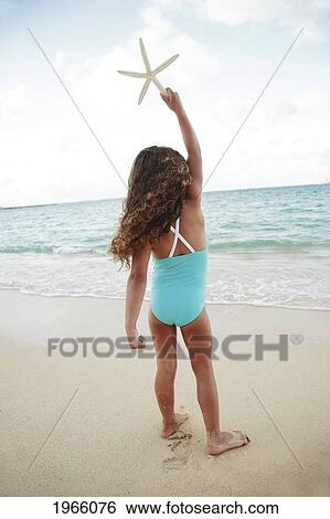 Hawaii, Oahu, Lanikai, /Nyoung Girl Finds Starfish At Beach. View Large Photo Image Stock Photograph - Hawaii, Oahu, Lanikai, /Nyoung Girl Finds Starfish At Beach.. Fotosearch