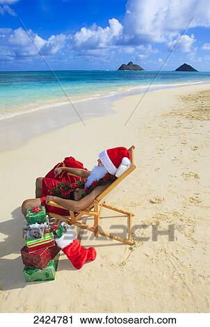 Hawaii, Oahu, Lanikai, Polynesian male dressed as Santa Claus relaxes at the beach. View Large Photo Image Stock Image - Hawaii, Oahu, Lanikai, Polynesian male dressed as Santa Claus relaxes at the beach.. Fotosearch