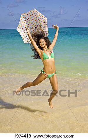 Hawaii, Oahu, Lanikai, Portrait Of Attractive Young Woman Jumping In The Water. View Large Photo Image Stock Photo - Hawaii, Oahu, Lanikai, Portrait Of Attractive Young Woman Jumping In The Water.. Fotosearch