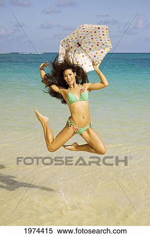 Hawaii, Oahu, Lanikai, Portrait Of Attractive Young Woman Jumping In The Water. View Large Photo Image Stock Photography - Hawaii, Oahu, Lanikai, Portrait Of Attractive Young Woman Jumping In The Water.. Fotosearch