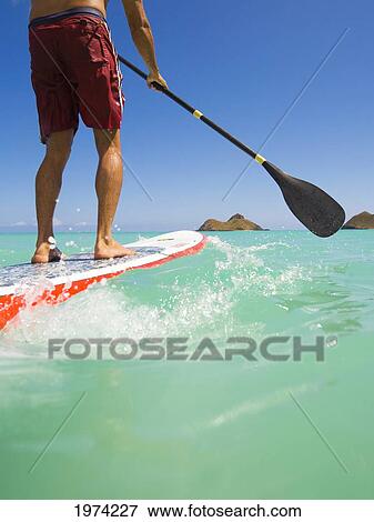 Stock Photo - Hawaii, Oahu, Lanikai, Stand Up Paddling.. Fotosearch