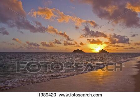Stock Image - Hawaii, Oahu, Lanikai, Sunrise With The Mokulua Islands In The Distance.. Fotosearch