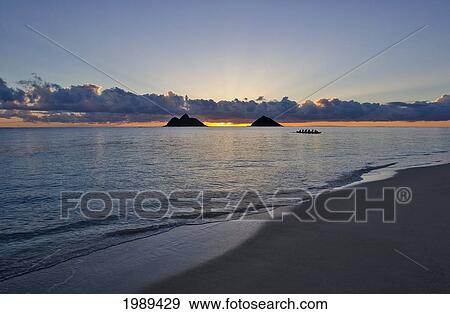 Hawaii, Oahu, Lanikai, Sunrise With The Mokulua Islands And Outrigger Canoe In The Distance. View Large Photo Image Stock Photo - Hawaii, Oahu, Lanikai, Sunrise With The Mokulua Islands And Outrigger Canoe In The Distance.. Fotosearch