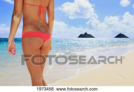 Stock Photograph - Hawaii, Oahu, Lanikai, View From Behind Of A Woman With The Mokulua Islands In The Background.. Fotosearch