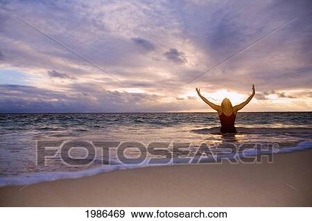 Stock Photo - Hawaii, Oahu, Lanikai, Woman Doing Yoga On The Beach At Sunrise.. Fotosearch
