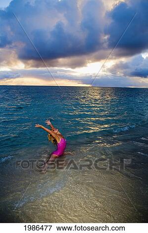 Hawaii, Oahu, Lanikai, Woman Doing Yoga On The Beach At Sunrise. View Large Photo Image Stock Photo - Hawaii, Oahu, Lanikai, Woman Doing Yoga On The Beach At Sunrise.. Fotosearch