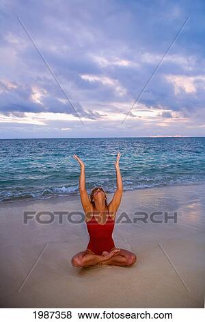 Stock Photo - Hawaii, Oahu, Lanikai, Woman Doing Yoga On The Beach At Sunrise.. Fotosearch
