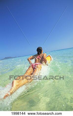 Hawaii, Oahu, Lanikai, Woman Jumping Into Ocean With Surfboard View Large Photo Image Picture - Hawaii, Oahu, Lanikai, Woman Jumping Into Ocean With Surfboard. Fotosearch