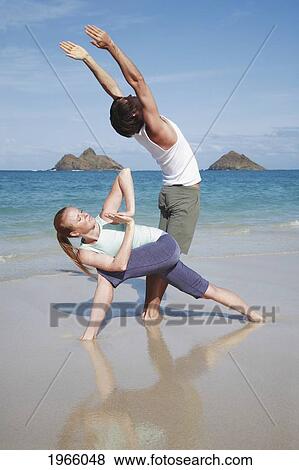 Stock Photo - Hawaii, Oahu, Lanikai, Young Couple Do Yoga On Beach.. Fotosearch