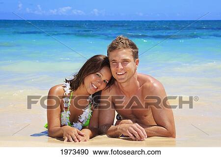 Stock Image - Hawaii, Oahu, Lanikai, Young Couple On The Beach.. Fotosearch