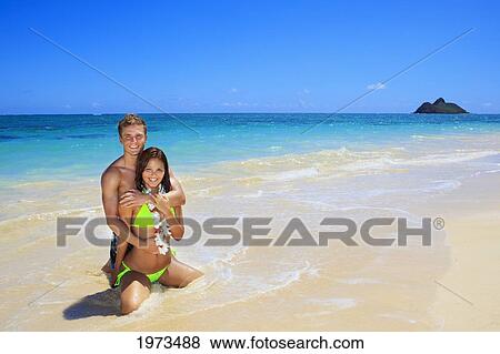Stock Photo - Hawaii, Oahu, Lanikai, Young Couple On The Beach.. Fotosearch
