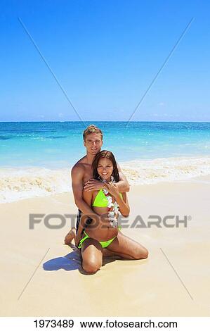 Stock Photo - Hawaii, Oahu, Lanikai, Young Couple On The Beach.. Fotosearch