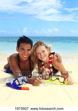 Hawaii, Oahu, Lanikai, Young Couple On The Beach With Snorkel Gear. View Large Photo Image Stock Photo - Hawaii, Oahu, Lanikai, Young Couple On The Beach With Snorkel Gear.. Fotosearch