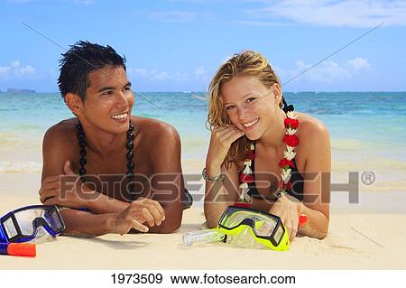 Stock Photo - Hawaii, Oahu, Lanikai, Young Couple On The Beach With Snorkel Gear.. Fotosearch