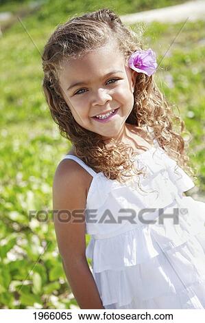 Stock Photography - Hawaii, Oahu, Lanikai, Young Girl Poses With Flower In Her Hair.. Fotosearch