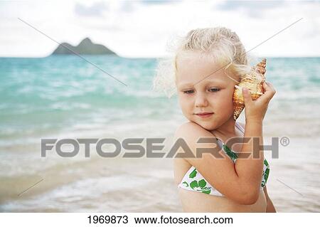 Hawaii, Oahu, Lanikai, Young Girl Listening To A Shell. View Large Photo Image Stock Image - Hawaii, Oahu, Lanikai, Young Girl Listening To A Shell.. Fotosearch