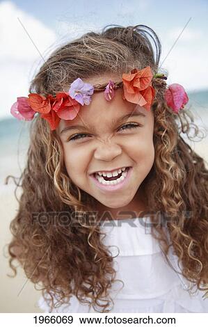 Stock Photo - Hawaii, Oahu, Lanikai, Young Girl Wearing Flower Headband Makes Funny Face At Beach.. Fotosearch