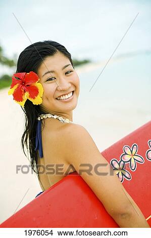 Picture - Hawaii, Oahu, Lanikai, Young Japanese Woman Holding Surfboard.. Fotosearch