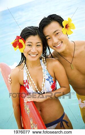 Hawaii, Oahu, Lanikai, Young Japanese Couple Holding Surfboards. View Large Photo Image Stock Photo - Hawaii, Oahu, Lanikai, Young Japanese Couple Holding Surfboards.. Fotosearch