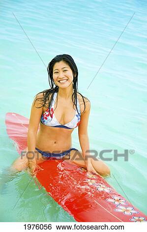 Hawaii, Oahu, Lanikai, Young Japanese Woman Sitting On Surfboard. View Large Photo Image Stock Photograph - Hawaii, Oahu, Lanikai, Young Japanese Woman Sitting On Surfboard.. Fotosearch