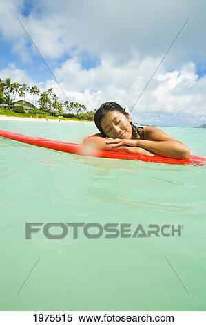 Hawaii, Oahu, Lanikai, Young Japanese Woman Lying On Surfboard In The Ocean. View Large Photo Image Stock Photography - Hawaii, Oahu, Lanikai, Young Japanese Woman Lying On Surfboard In The Ocean.. Fotosearch