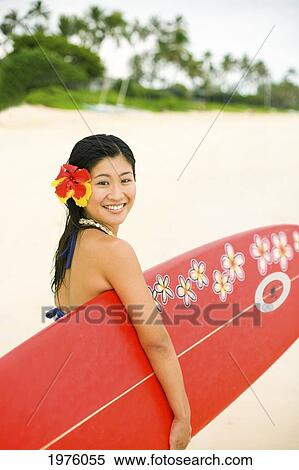 Stock Photography - Hawaii, Oahu, Lanikai, Young Japanese Woman Holding Surfboard.. Fotosearch