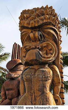Hawaii, Oahu, Large Wooden Tiki Statues Greet Visitors Outside Of The Polynesian Cultural Center Entrance. Editorial Use Only. View Large Photo Image Stock Photograph - Hawaii, Oahu, Large Wooden Tiki Statues Greet Visitors Outside Of The Polynesian Cultural Center Entrance. Editorial Use Only.. Fotosearch