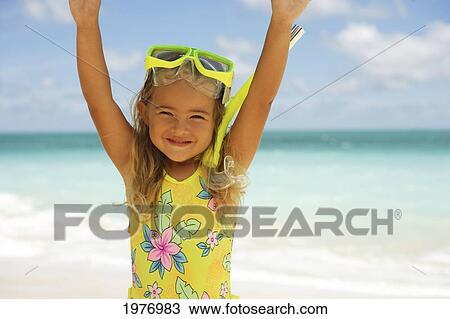 Stock Image - Hawaii, Oahu, Little Girl Poses On Beach With Snorkel.. Fotosearch