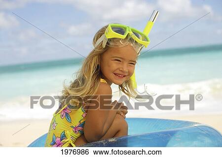 Stock Photograph - Hawaii, Oahu, Little Girl Poses On Beach With Snorkel.. Fotosearch