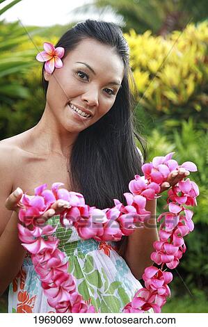 Hawaii, Oahu, Local Female Lei Greeter Holding A Pink Plumeria Lei View Large Photo Image Stock Photo - Hawaii, Oahu, Local Female Lei Greeter Holding A Pink Plumeria Lei. Fotosearch
