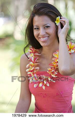 Hawaii, Oahu, Local Girl Holding Yellow Plumeria Behind Her Ear And A Plumeria Lei Around Her Neck. View Large Photo Image Stock Photo - Hawaii, Oahu, Local Girl Holding Yellow Plumeria Behind Her Ear And A Plumeria Lei Around Her Neck.. Fotosearch
