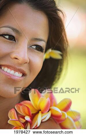 Hawaii, Oahu, Local Girl With Yellow Plumeria Behind Her Ear And A Plumeria Lei Around Her Neck. View Large Photo Image Stock Photo - Hawaii, Oahu, Local Girl With Yellow Plumeria Behind Her Ear And A Plumeria Lei Around Her Neck.. Fotosearch