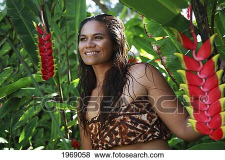 Hawaii, Oahu, Local Polynesian Female Wearing Tapa Smiling In A Jungle Forest Of Heliconia Plants View Large Photo Image Stock Photo - Hawaii, Oahu, Local Polynesian Female Wearing Tapa Smiling In A Jungle Forest Of Heliconia Plants. Fotosearch