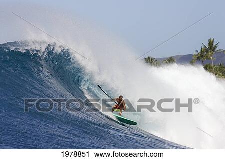 Stock Image - Hawaii, Oahu, Makaha, Brian Keaulana Paddle Surfing A Big Wave.. Fotosearch