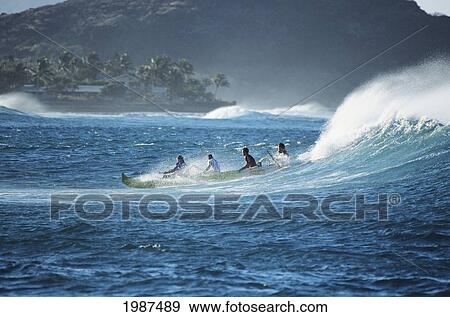 Hawaii, Oahu, Makaha, Distant View Of Men In Outrigger Canoe Surfing Wave. No Model Release View Large Photo Image Stock Photo - Hawaii, Oahu, Makaha, Distant View Of Men In Outrigger Canoe Surfing Wave. No Model Release. Fotosearch