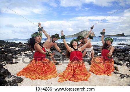 Stock Photograph - Hawaii, Oahu, Makapu'u Beach, Group Of Tahitian Male And Female Dancers Posing, Rabbit Island In Background.. Fotosearch