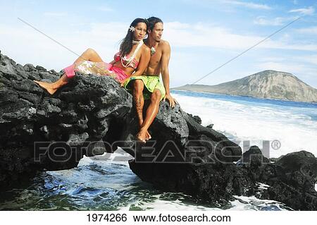 Hawaii, Oahu, Makapuu, Male And Female Hula Dancers Sit On A Rock Posing. View Large Photo Image Stock Photograph - Hawaii, Oahu, Makapuu, Male And Female Hula Dancers Sit On A Rock Posing.. Fotosearch