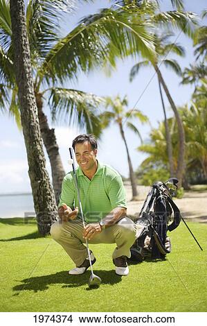 Picture - Hawaii, Oahu, Male Golfer On Golf Course.. Fotosearch