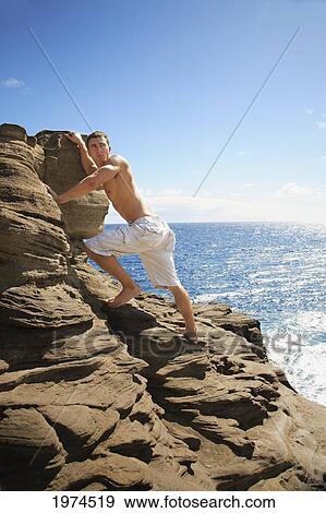 Hawaii, Oahu, Male Rock Climbing. View Large Photo Image Stock Photo - Hawaii, Oahu, Male Rock Climbing.. Fotosearch