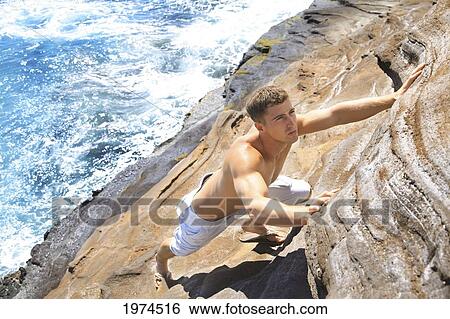 Stock Photograph - Hawaii, Oahu, Male Rock Climbing.. Fotosearch