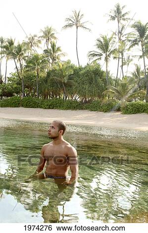 Hawaii, Oahu, Male Standing In The Ocean. View Large Photo Image Stock Photograph - Hawaii, Oahu, Male Standing In The Ocean.. Fotosearch