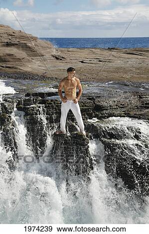Hawaii, Oahu, Male Wearing White Pants On Rocky Cliff. View Large Photo Image Stock Photo - Hawaii, Oahu, Male Wearing White Pants On Rocky Cliff.. Fotosearch