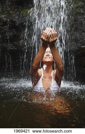 Hawaii, Oahu, Manoa Falls, Beautiful Female Sitting At The Bottom Of Manoa Waterfall, Cupping Water Above Her. View Large Photo Image Stock Image - Hawaii, Oahu, Manoa Falls, Beautiful Female Sitting At The Bottom Of Manoa Waterfall, Cupping Water Above Her.. Fotosearch