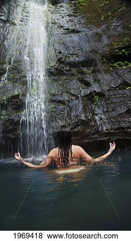 Stock Photo - Hawaii, Oahu, Manoa Falls, Beautiful Female Sitting In A Pond At The Bottom Of Manoa Waterfalls Meditating.. Fotosearch