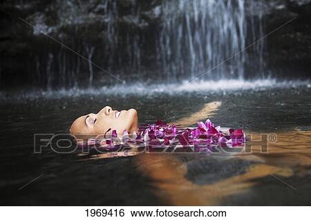 Hawaii, Oahu, Manoa Falls, Beautiful Female With Orchids Leis Floating At The Bottom Of Manoa Waterfalls. View Large Photo Image Stock Photograph - Hawaii, Oahu, Manoa Falls, Beautiful Female With Orchids Leis Floating At The Bottom Of Manoa Waterfalls.. Fotosearch