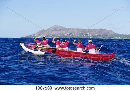Stock Photo - Hawaii, Oahu, Men Paddling Outrigger Canoe, Backside Of Diamond Head In Distance, View From Behind. No Model Release. Fotosearch
