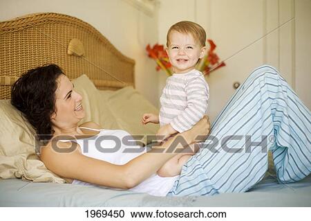Hawaii, Oahu, Mother And Her Baby On The Bed. View Large Photo Image Stock Image - Hawaii, Oahu, Mother And Her Baby On The Bed.. Fotosearch