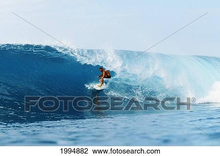 Stock Image - Hawaii, Oahu, North Shore, Backdoor Pipe, Pancho Sullivan Riding Wave. Fotosearch