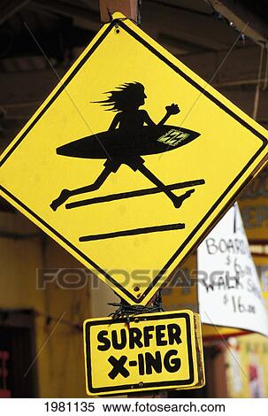 Stock Photography - Hawaii, Oahu, North Shore, Haleiwa, Surfer Crossing Sign.. Fotosearch