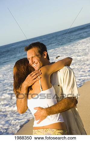 Hawaii, Oahu, North Shore, Happy Couple Embracing On Beach In Warm Afternoon Light. View Large Photo Image Stock Image - Hawaii, Oahu, North Shore, Happy Couple Embracing On Beach In Warm Afternoon Light.. Fotosearch